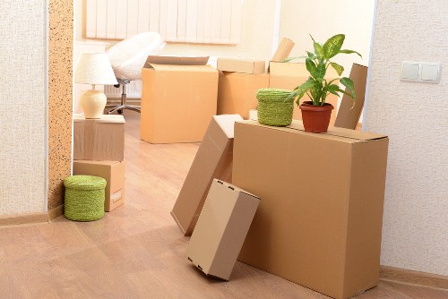 Movers carrying furniture through a narrow Hampstead staircase